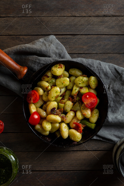Overhead view of pan full of homemade potato gnocchi with pesto