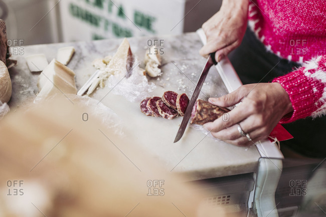 Man cutting meat on chopping board stock photo