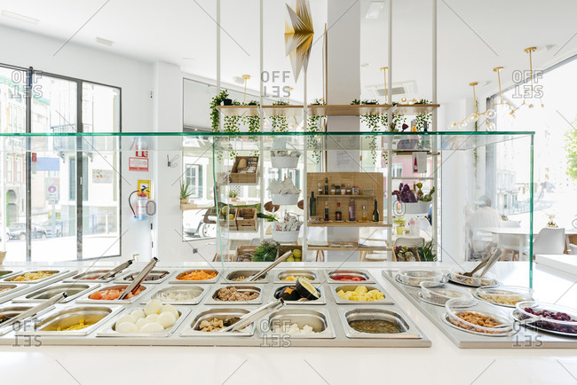 Modern restaurant with self service system and served delicious foods and dishes in metal warm container on counter