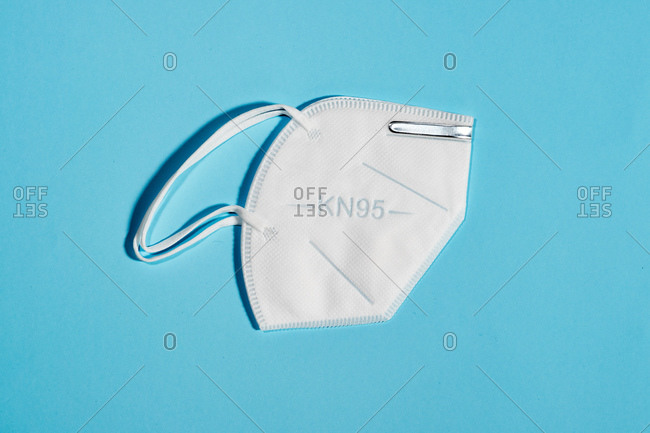 White mask with reusable KN95 protection index for virus protection on light blue background
