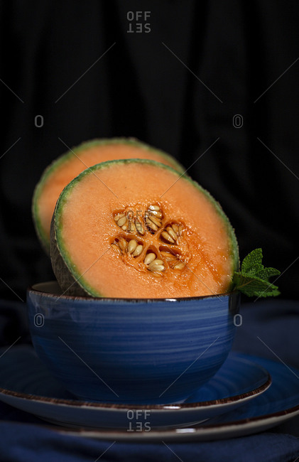Fresh assortment melon with mint  on dark background. Vegan food concept. Healthy food