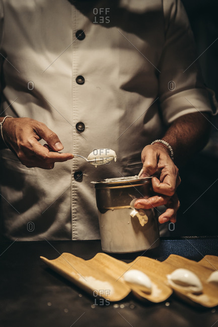 Professional chef preparing ice cream dessert