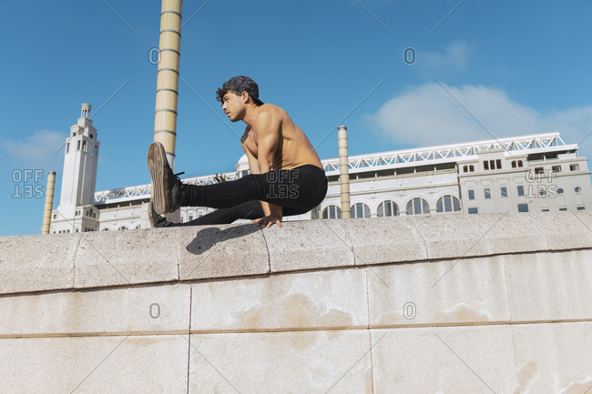 Young man doing acrobatics outdoors