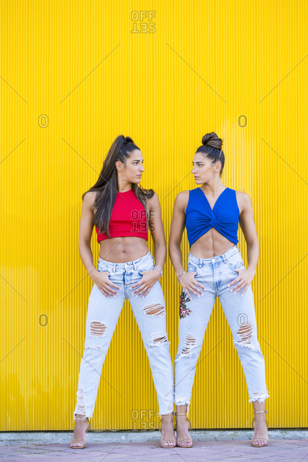 twins in front of yellow wall
