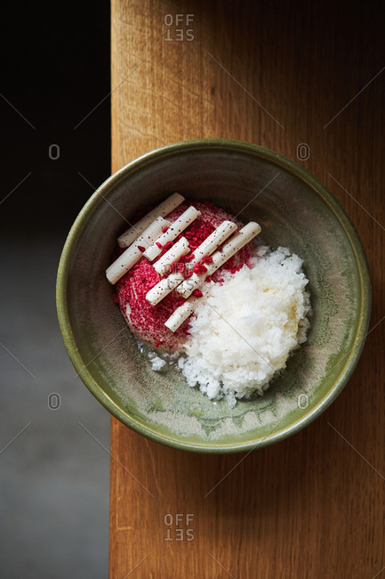 Beautiful dessert of lemon granita, creme brulee ice cream, meringue cylinders and dehydrated raspberry