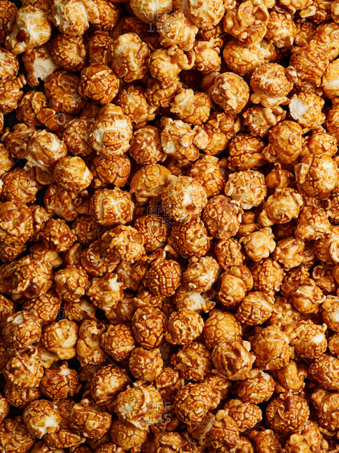Top view of scattered gourmet caramel popcorn (background and texture)
