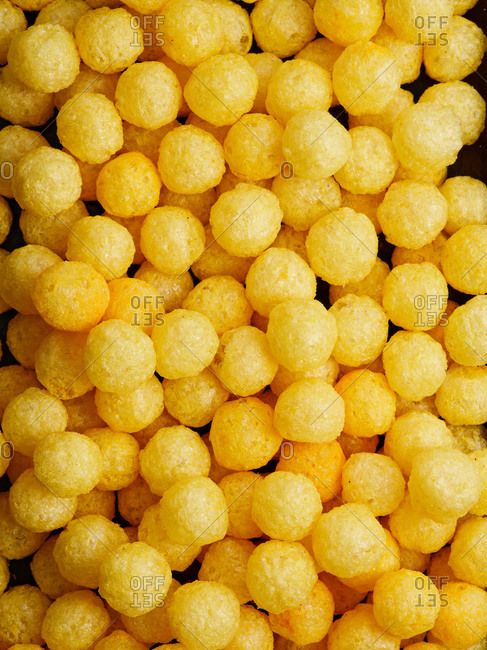 Yellow salty and savory cheese flavored corn puffs