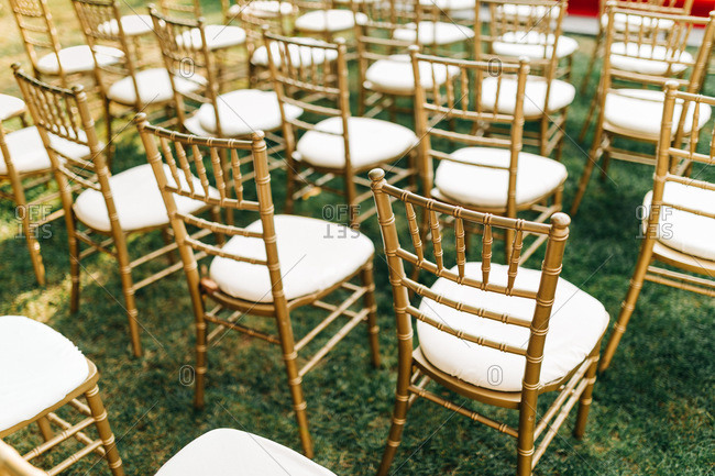 Gold chairs at outdoor garden wedding