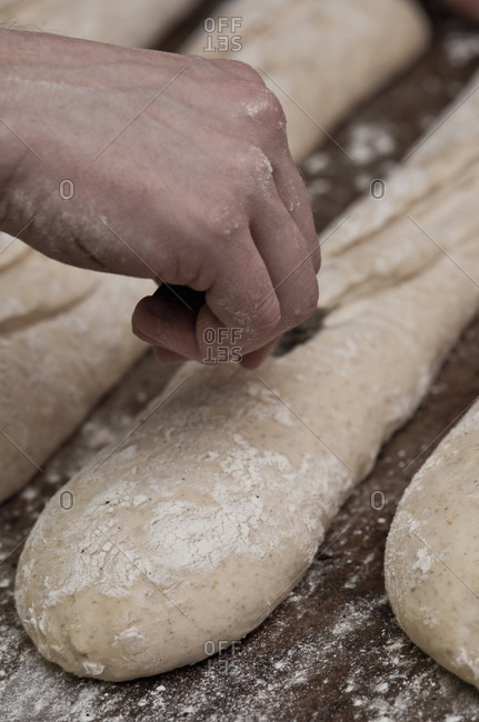 Baker preparing baguettes at bakery