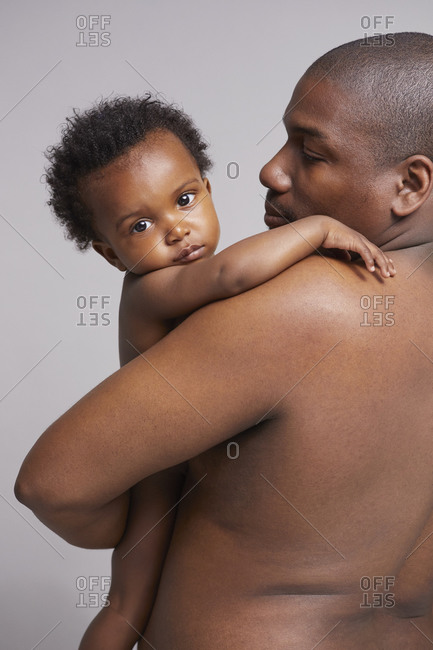 Black father holding baby in his arms