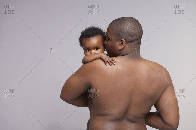 Black father holding infant in his arms