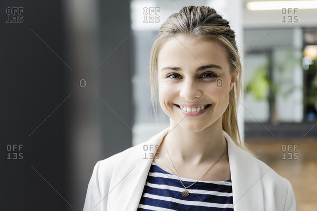 Portrait of female student at corridor of office building