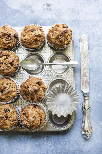 Freshly baked chocolate chip muffins on baking pan