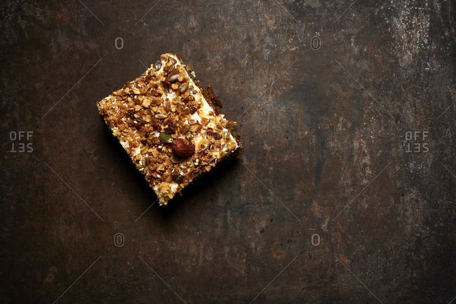 Piece of carrot cake straight out of the oven on dark background