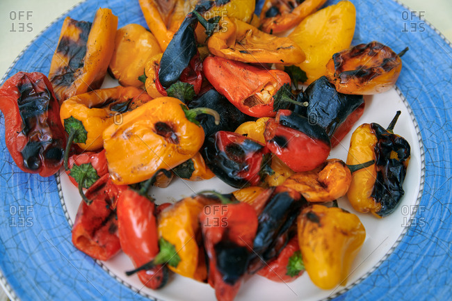 Freshly cooked juicy grilled peppers on a plate. BBQ themes
