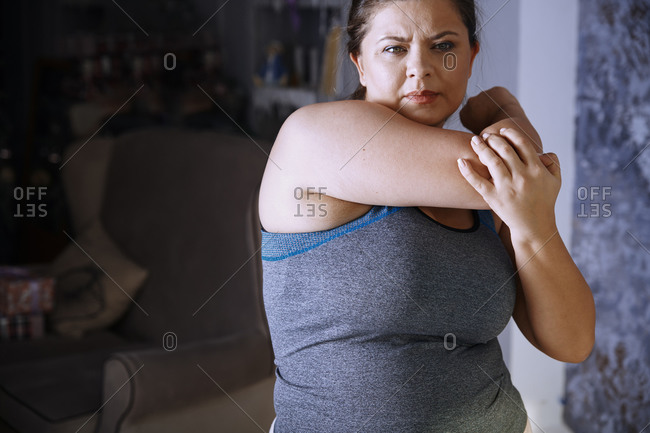 Plus size woman doing sports exercise at home