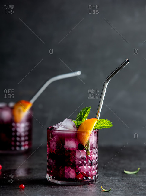 Drink with blackberries, raspberries and cranberries in glasses on a table