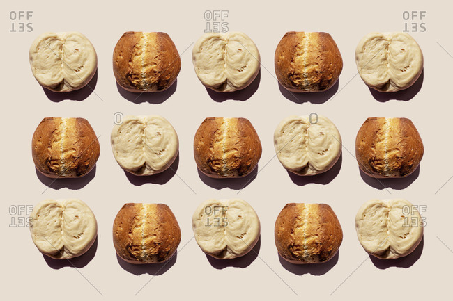 Pattern of rows of raw dough lumps and baked breads