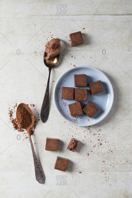 Two teaspoons and bunch of pralines with chocolate ganache