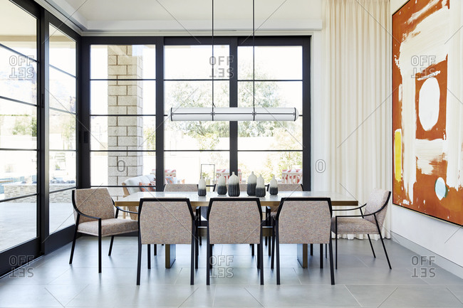 Paradise Valley, Arizona - July 9, 2019: Large modern dining room table in a room with large windows