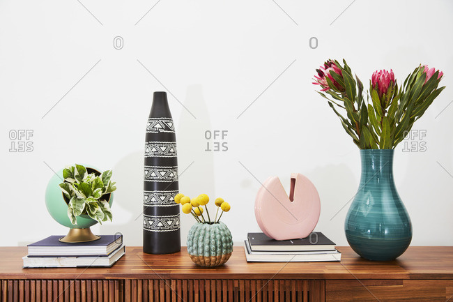 April 1, 2020: Books, flowers and decorative items on a wooden side table
