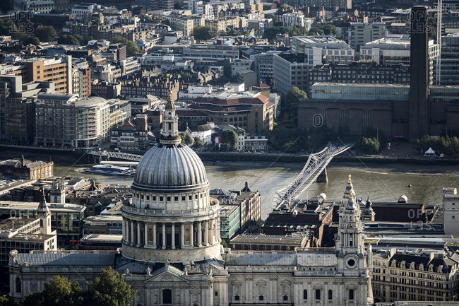 High angle view of the dome of St Pauls Cathedral designed by Christopher Wren, and Millennium Bridge and Tate Modern across the River Thames in London