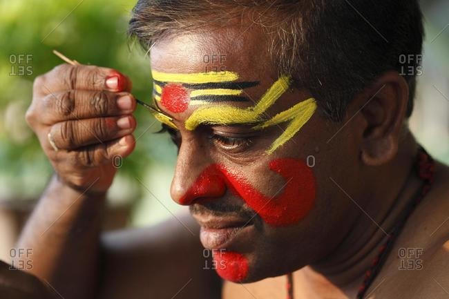 Kathakali dancer doing his make up, Chuvanna Thaadi mask, Kerala, southern India, Asia