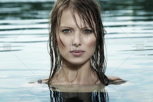 Young woman with wet hair standing in water
