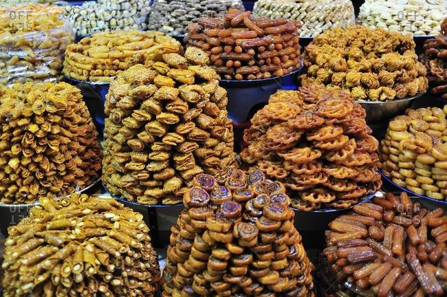 Sweets baked in oil being sold in the souk, bazaar, for Ramadan, Meknes, Morocco, Africa