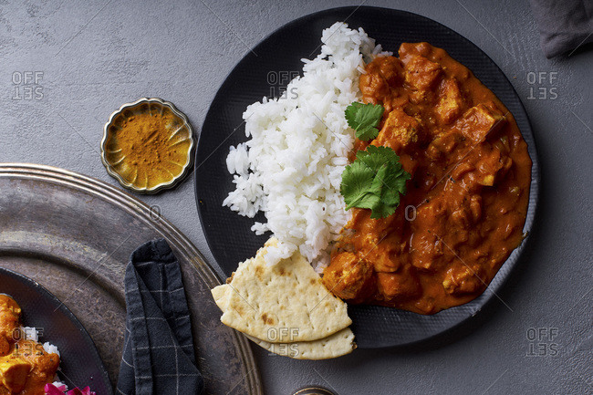 Paneer tikka masala with basmati rice. Indian cuisine, vegetarian dish made of soft cheese cubes cooked in spicy tomato sauce with cream. Top view.