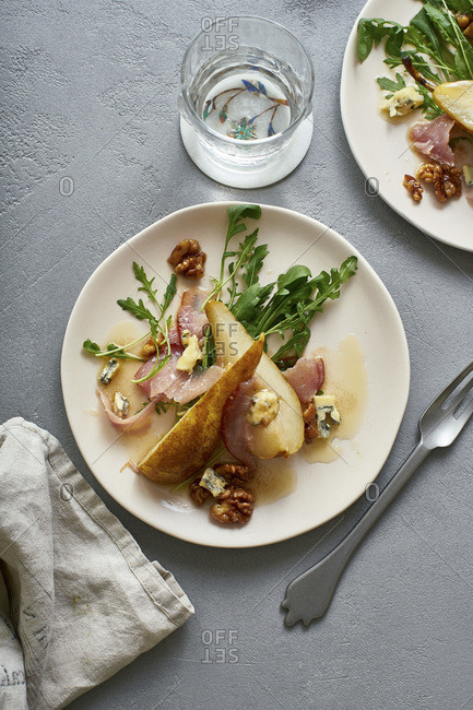 Pear salad with walnuts, prosciutto, arugula and blue cheese. Dinner appetizer
