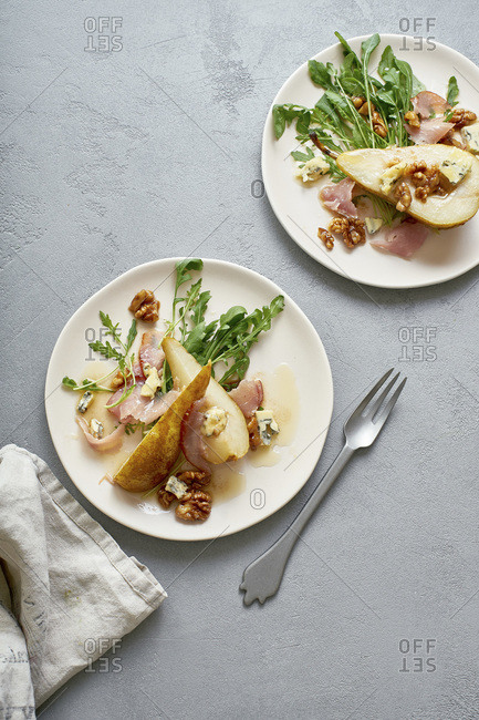 Pear salad with walnuts, prosciutto, arugula and blue cheese. Dinner appetizer