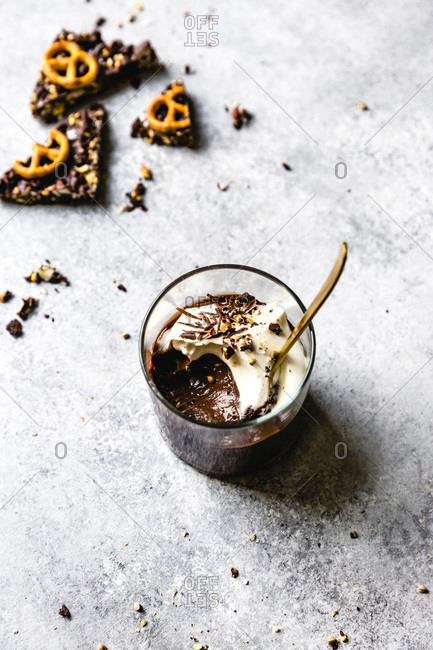 Chocolate pudding in a glass with whipped coconut cream and chocolate shavings.