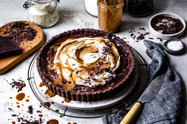 Chocolate caramel tart with whipped coconut cream, caramel and  chocolate shavings.