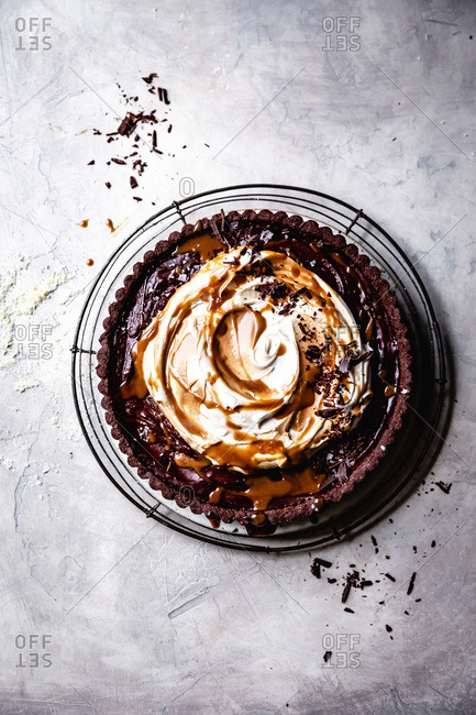 Chocolate caramel tart with whipped coconut cream and chocolate shavings.