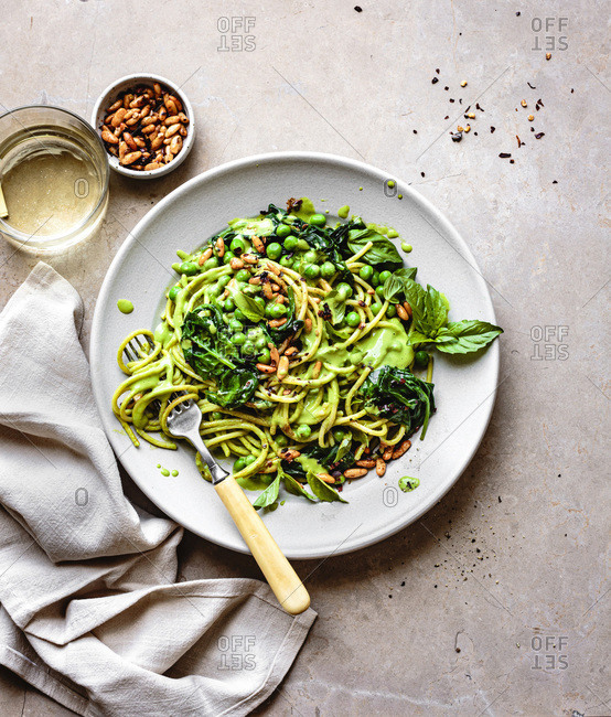Creamy pea pasta with spicy pine nuts.