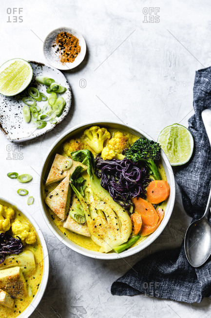 Thai curry with black rice noodles, tofu, carrot, broccolini, bok choy, cauliflower, lime, scallions