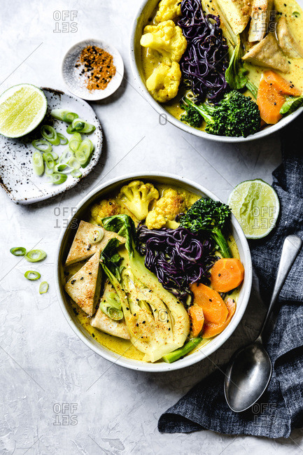 Thai curry with black rice noodles, tofu, carrot, broccolini, bok choy, cauliflower, lime, scallions