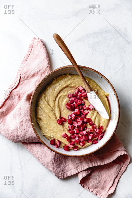Pieces of rhubarb and cake batter in a bowl.