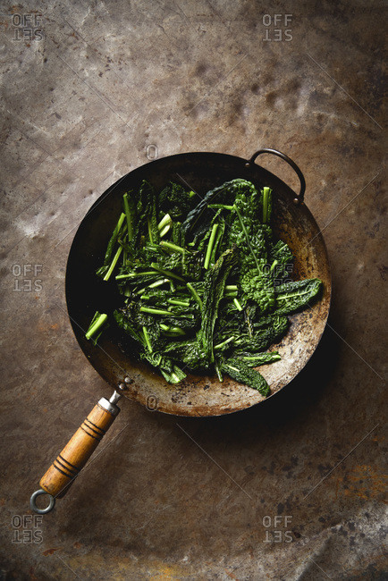 Cooked Kale in Wok with fresh ingredients