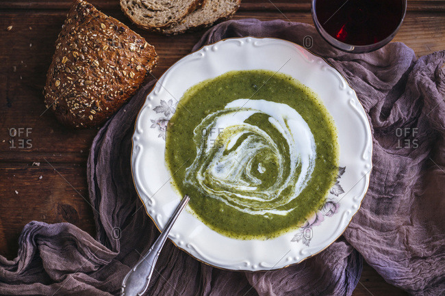Broccoli soup with yogurt served in a vintage plate