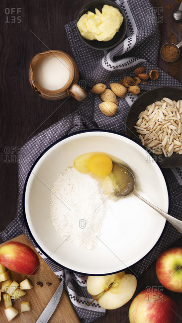 Rustic scene showing ingredients for an apple cake.