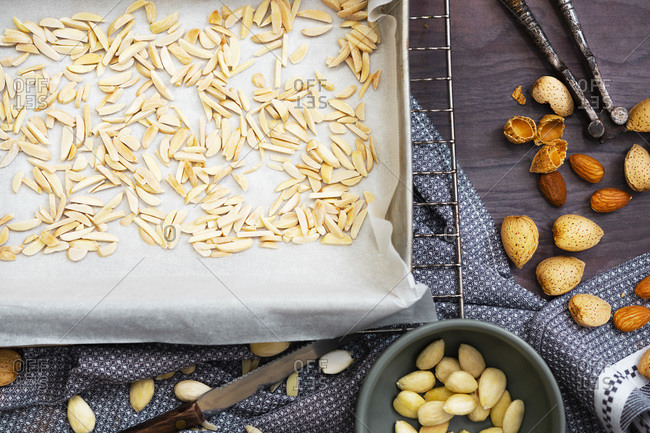 Toasted slithered almonds on a baking tray.