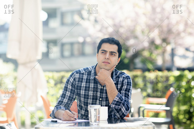 Young man in deep thought at cafe