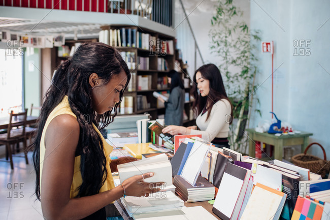 Young businesswomen browsing books in bookshop
