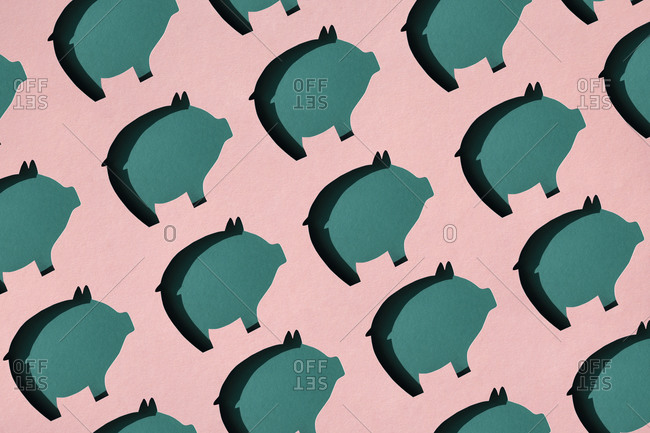 Pattern of rows of pig shaped paper cuts against pink background