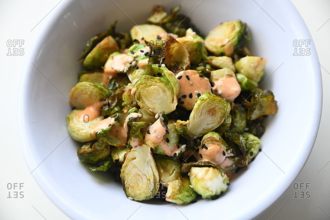 Roasted brussels sprouts with sauce and sesame seeds