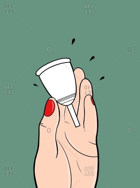Woman is holding white menstrual cup in her hand