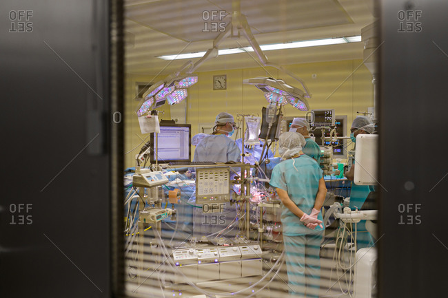 Looking in through window while surgery is being performed in a hospital operating room