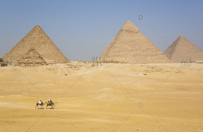Tourists riding camels, Great Pyramids of Giza, UNESCO World Heritage Site, Giza, Egypt, North Africa, Africa